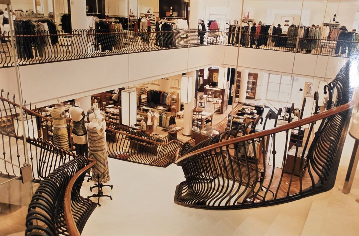 View down the stone grand staircase inside Richards of Greenwich, with its curving iron railings